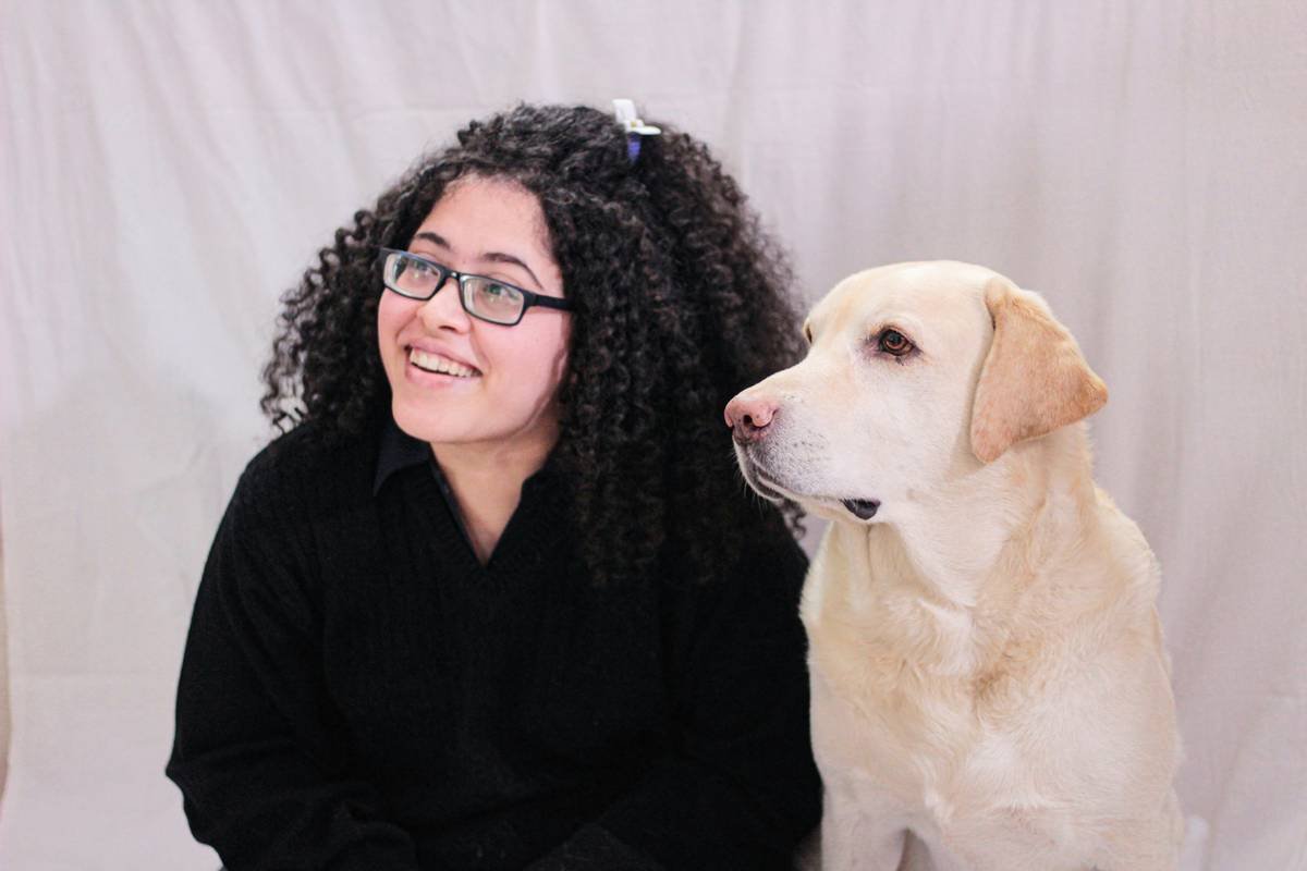 community support help living a deaf dog owner using hand signals in a park with trainer nearby
